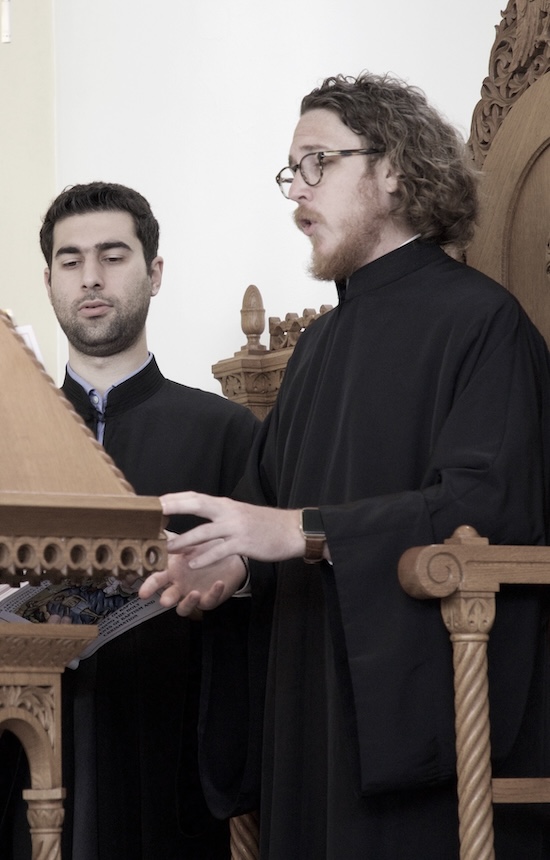 Joshua Boyd chanting at the analogion